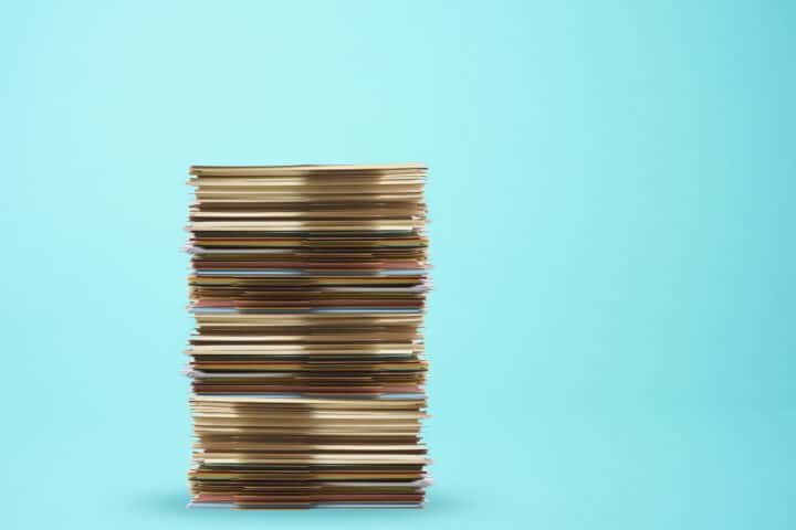 Piled up file folder on light blue background