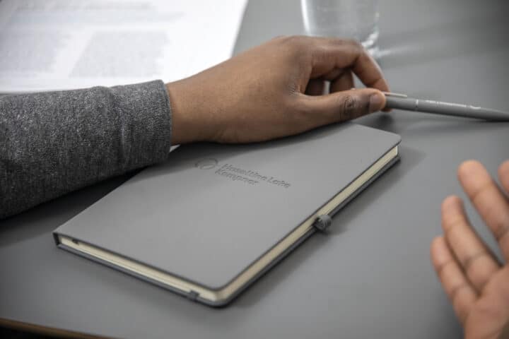 Grey HLK notebooks on a table
