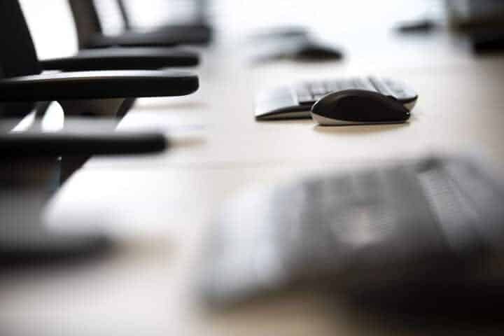 Computer keyboards and mice on a desk